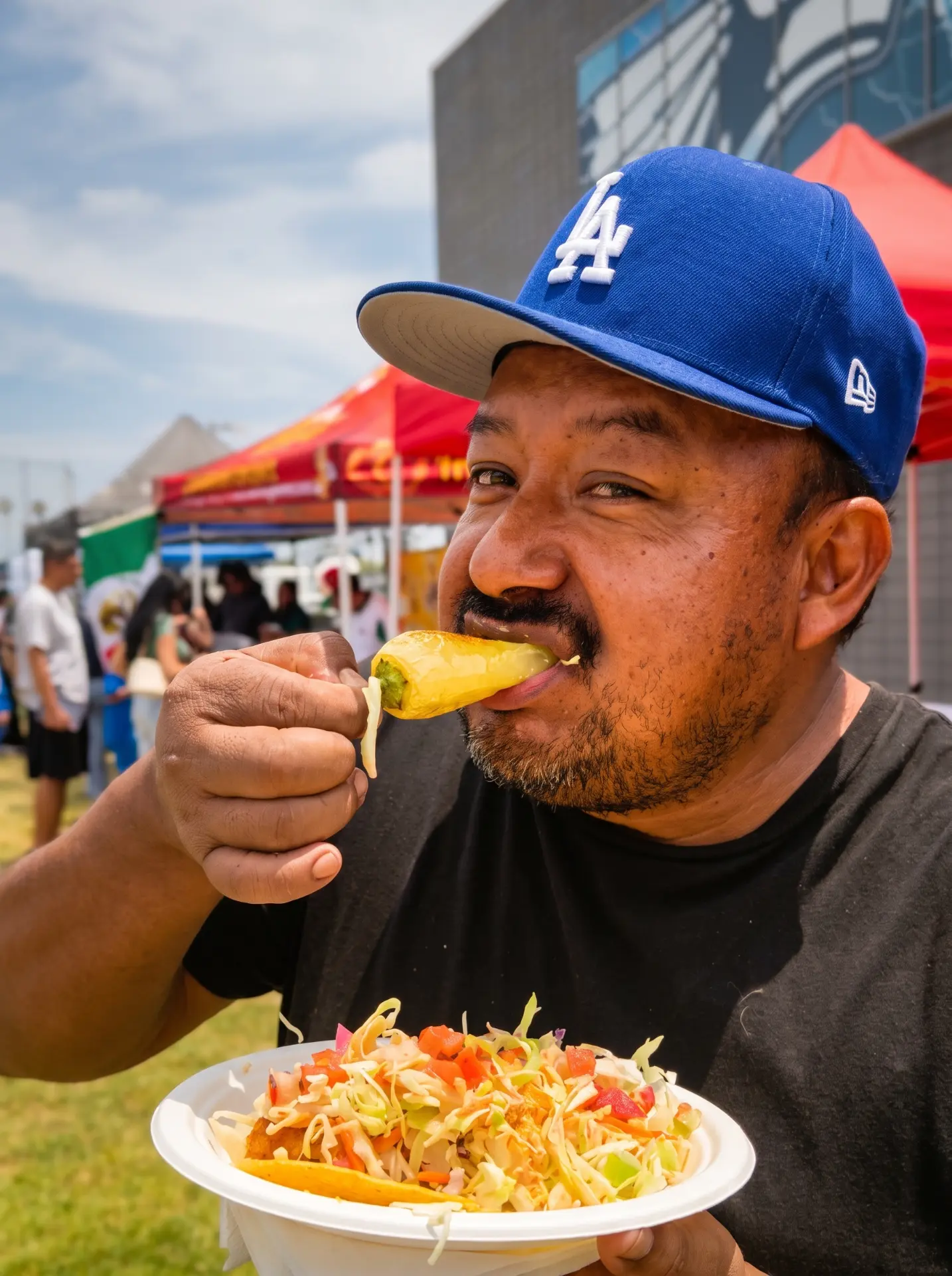 Happy customer eating a roasted chile at the taco truck
